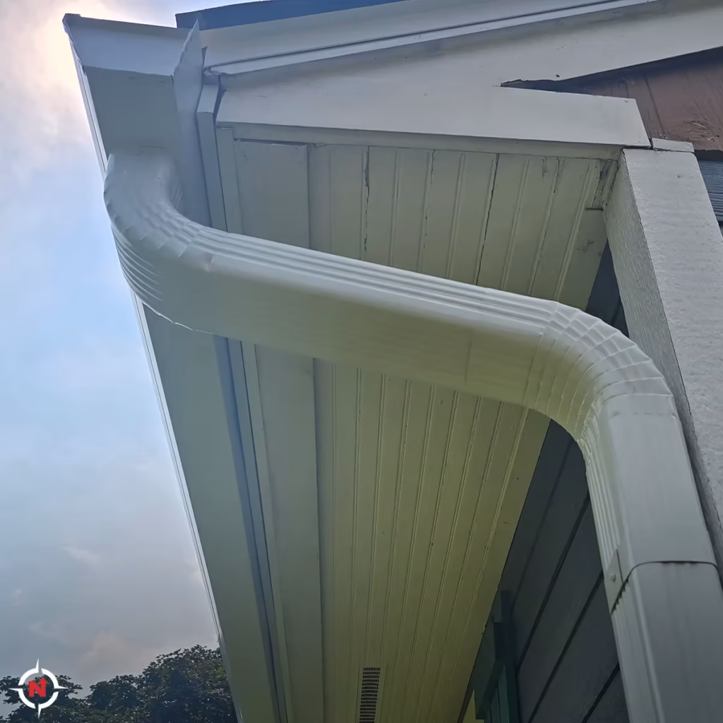 Custom-fit gutter downspout elbow and drainage detail on a Wisconsin home