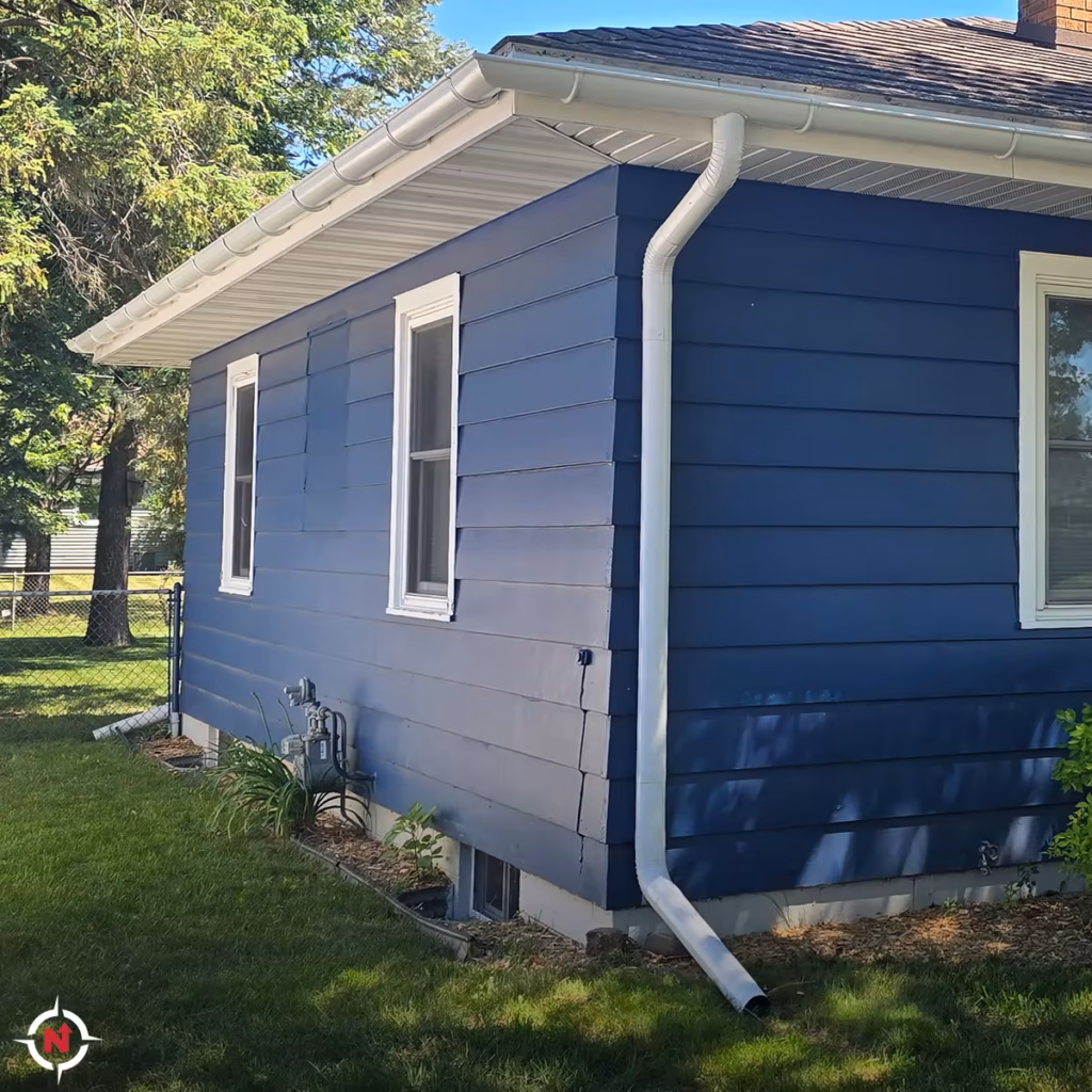 White half-round gutters and downspouts installed on an Eau Claire area home